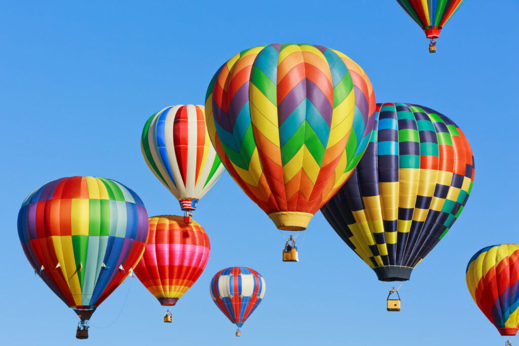 Hot air balloons take flight in the air.